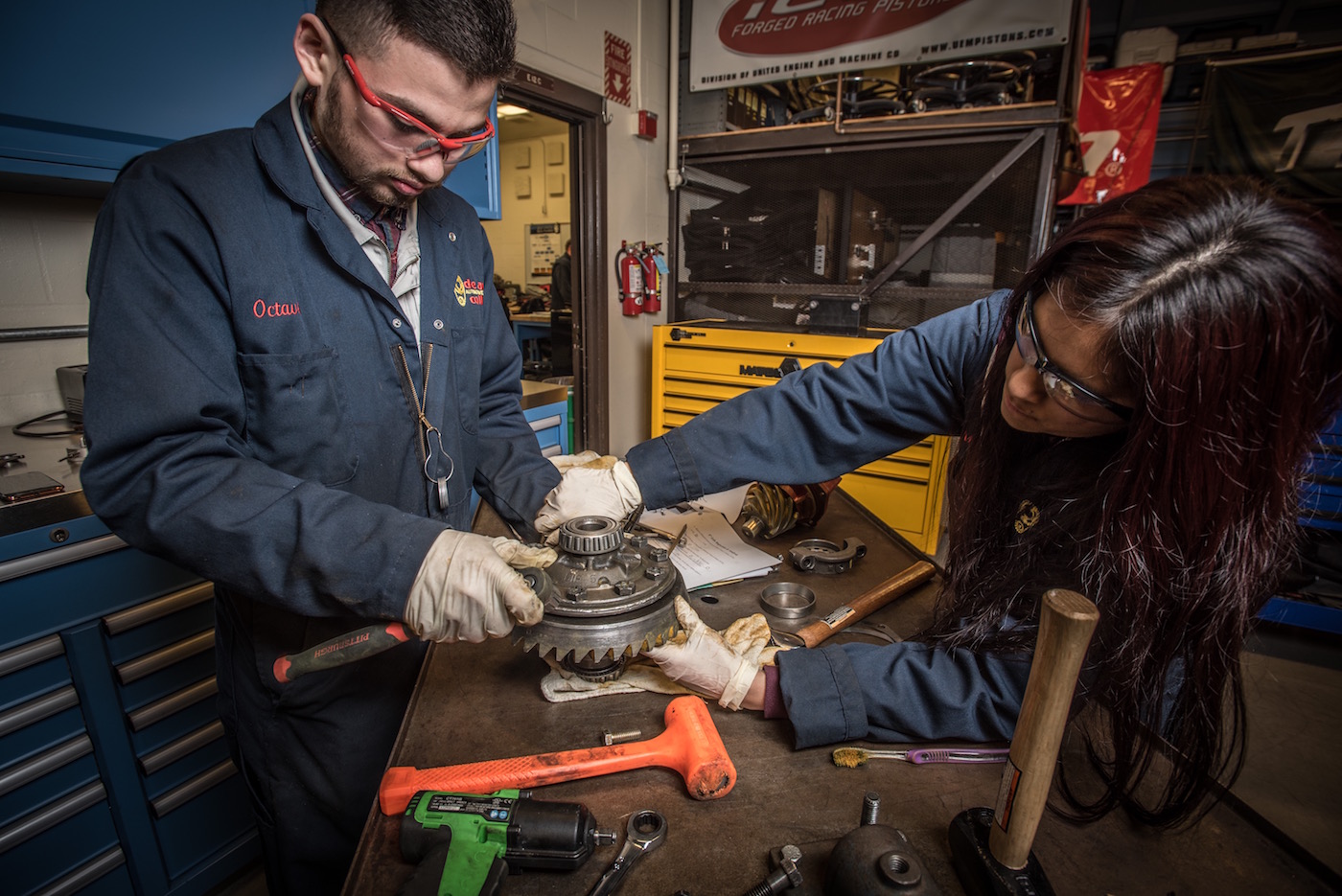 two students adjusting gear