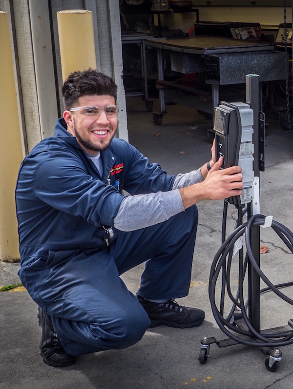 student with electrical equipment