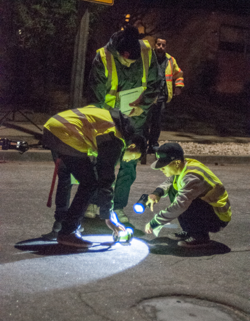 students inspecting street