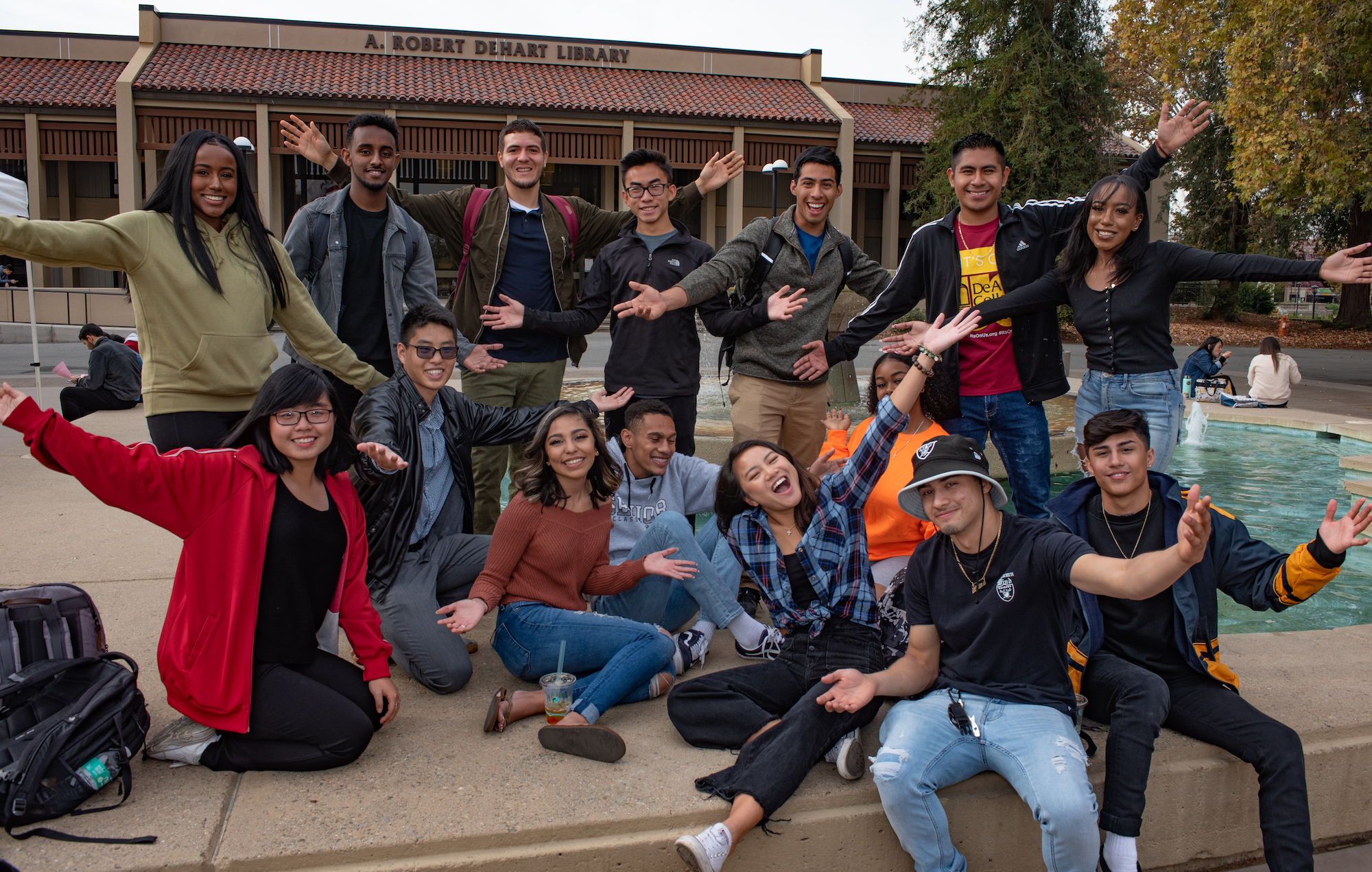 students in group in front of fountain