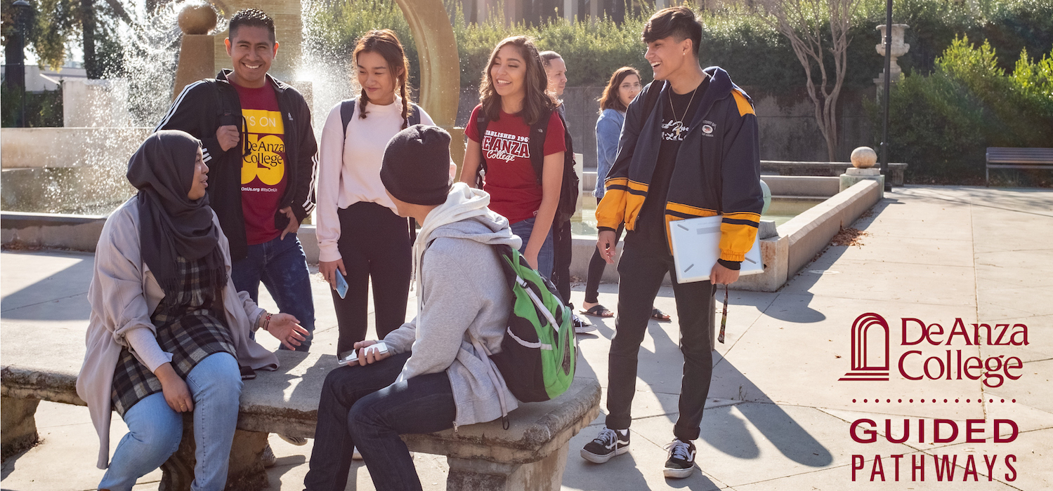 students talking in group near fountain