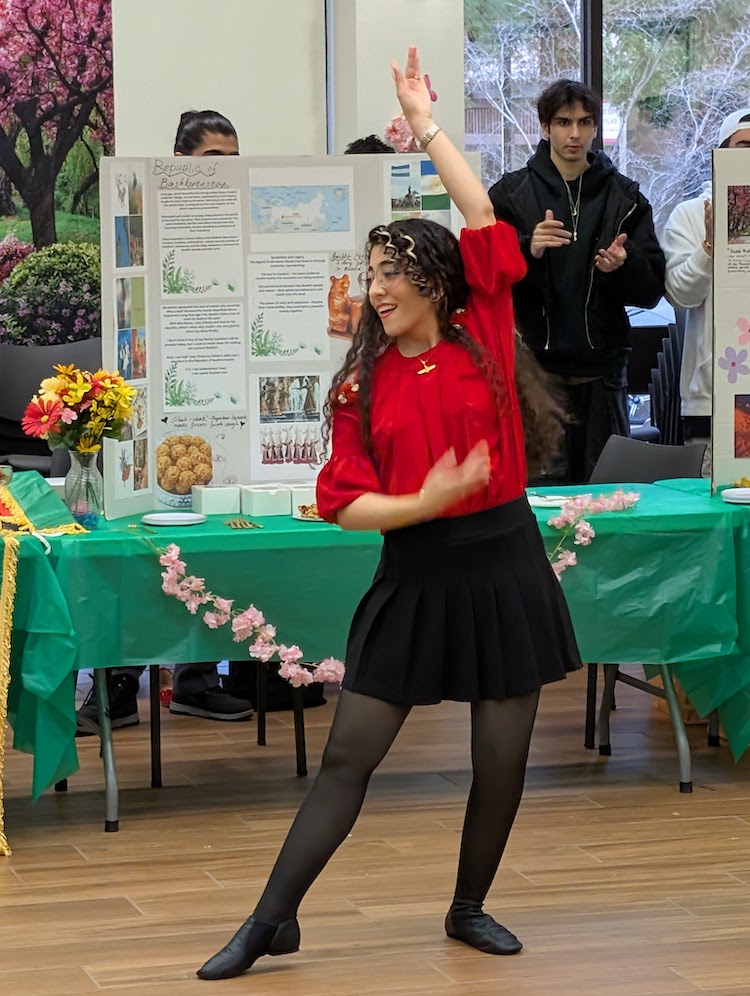 young woman in red with arms up