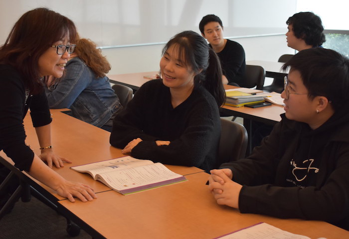 teacher at table with students