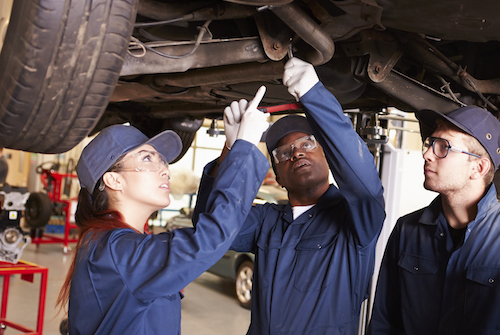 auto tech students under car