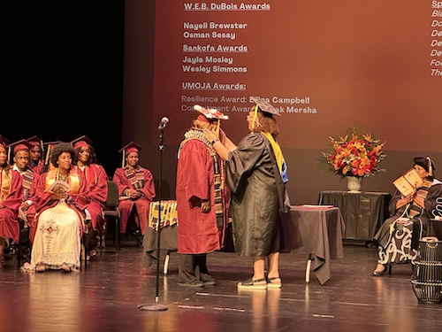 student getting sash