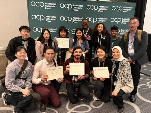 journalism students with award certificates