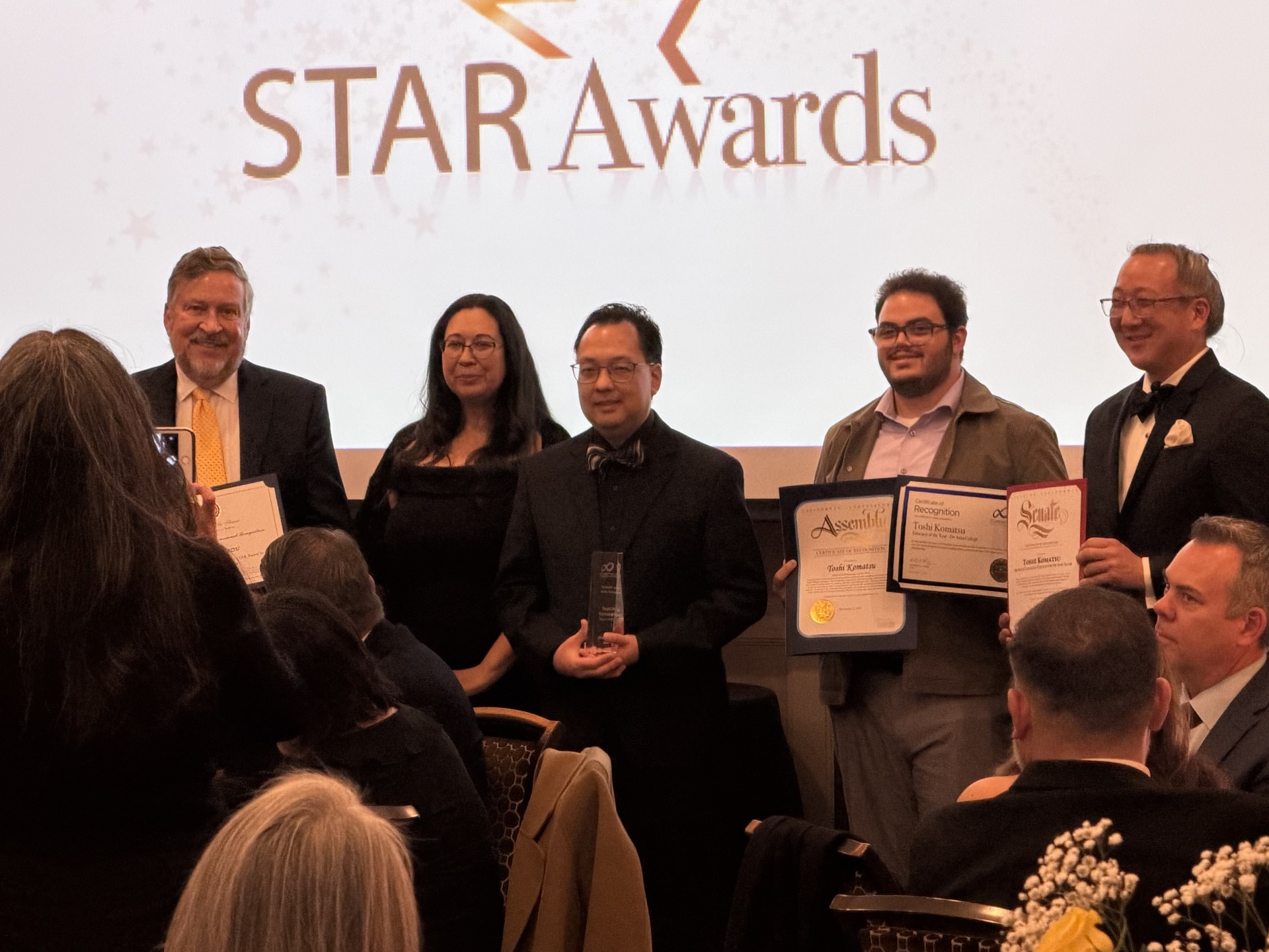 Toshi Komatsu, director of the Fujitsu Planetarium (center), accepts his STAR Award from the Cupertino Chamber of Commerce