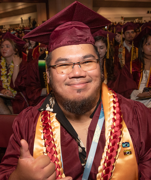 grad giving thumbs up