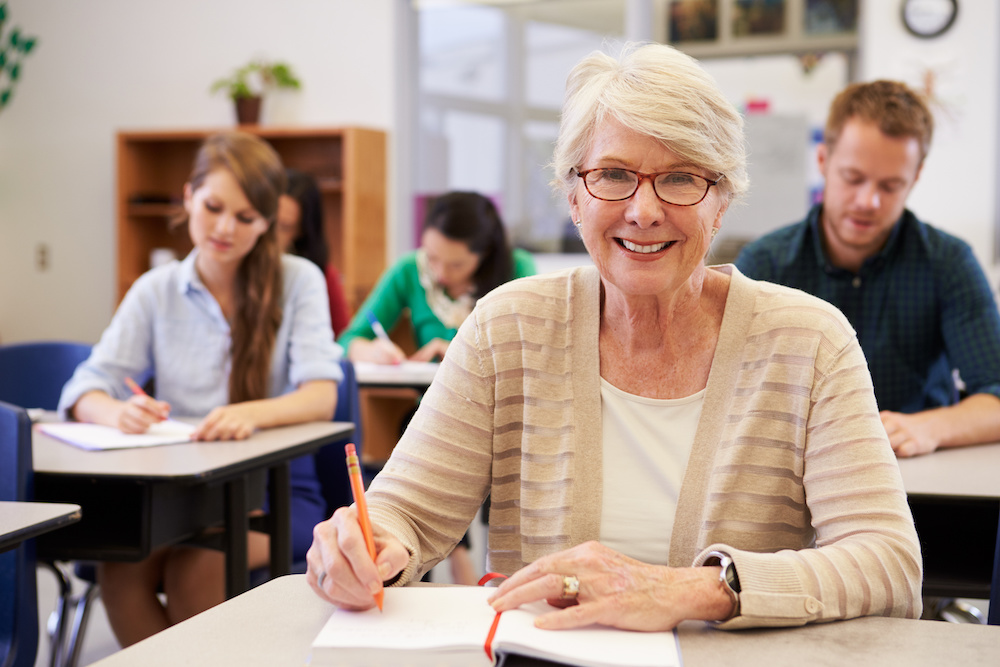 white-haired woman in classroom