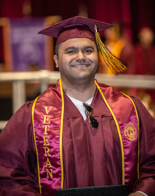 young man in grad cap with Veteran sash