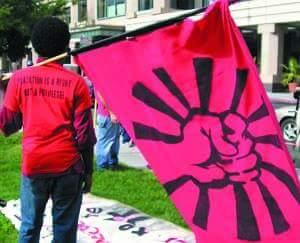 student with pink banner